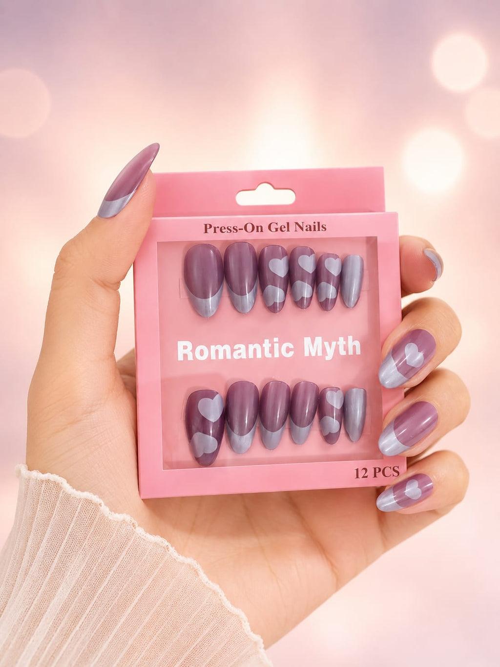 Romantic Myth press-on gel nails held in hand showing heart design